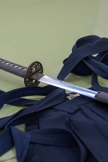 Japanese sword draped on a blue martial arts uniform with sashes, Aikaido, Calw, Germany