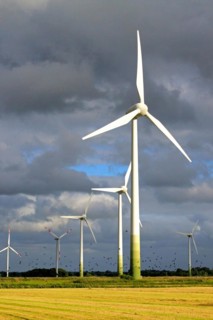 Wind turbines in front of a stormy sky in a rape field, East Frisia, Lower Saxony, Federal Republic
