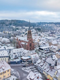 Snow-covered town with church in the centre, surrounded by houses, Nagold, Black Forest, Germany