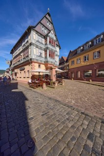 Gasthaus and Hotel Zum Riesen against blue sky with cirrostratus clouds in the main street,