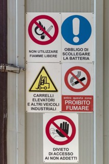 Warning signs on a factory gate, Veneto, Italy