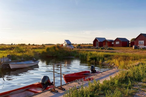 Traditional red fishing huts, holiday homes on the Baltic Sea coast, fishing port, campervan,