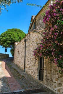 Picturesque narrow alley and wall on the edge of the medieval old town of Cervo, province of