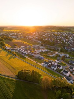 Aerial view of a quiet village surrounded by fields at sunset, Gechingen, Black Forest, Germany