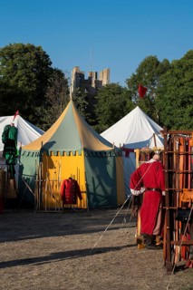Colourful round tents, man in medieval clothing, medieval market, medieval week, fortified defence