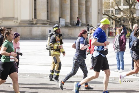 Runners in fire brigade gear at the 44th Generali Berlin Half Marathon 2025 in Berlin on 6 April