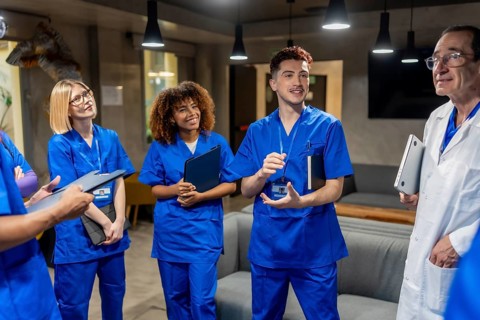 Diverse medical team members, including interns and an experienced doctor, collaborating in a
