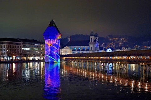 Wassertum with light installation, Chapel Bridge on the right, Jesuit Church on the Reuss at dusk