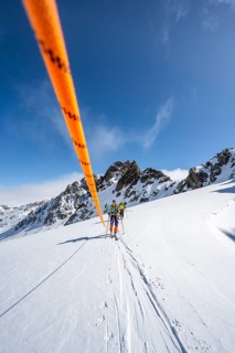 Ski tourer with rope, rope team on the Vadret da Porchabella glacier on the ascent to the summit of
