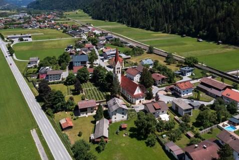 Drone shot, view of village with parish church, Schönwies, Oberinntal, Tyrol, Austria