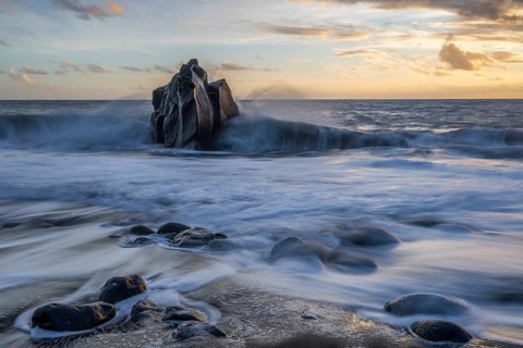 Sunset, waves and rocks in the sea, Praia Formosa, Madeira, Portugal