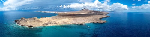 Headland and blue sea, coastal landscape, arid landscape of Los Ajaches Natural Park, aerial view,