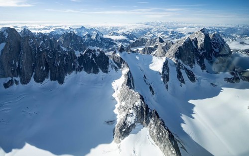 Rock cliffs, snow and ice, epic mountains with glaciers, aerial view, Alaska Range, Denali National