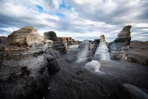 Eroded rock formations, volcanic landscape with dramatic cloudy skies, Ciudad Estratificada or Los