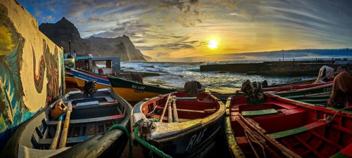 Boats in a colorful harbor illuminated by sunset light, graffiti, romantic harbor scene, Ponta do
