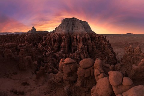 Mesmerizing sunset over sandstone formations in Goblin Valley State Park, Utah. The vibrant hues