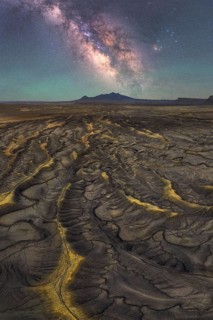 Stunning view of the Milky Way illuminating the sandstone ridges of a desert in Utah, USA. The