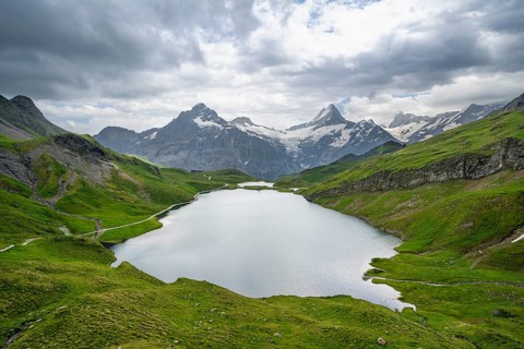 View of mountain landscape with Bachalpsee mountain lake, Finsteraarhorn peaks and Schreckhorn with