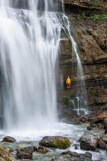 Adventure, Little hiker under large Cascata di Mezzo waterfall, long exposure, Vallesinella,