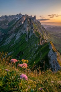 A breathtaking view of Altenalp Turm in Switzerland during sunset, showcasing rugged peaks and