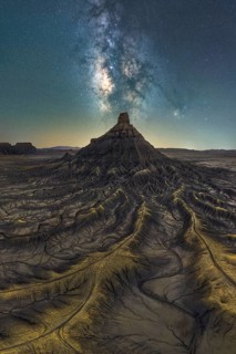 Spectacular view of the Milky Way galaxy illuminating a rugged sandstone desert landscape in Utah,