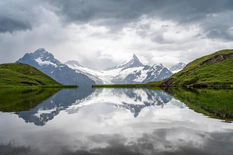 Mittelhorn and Schreckhorn peaks with Upper Grindelwald glacier are reflected in the Bachalpsee