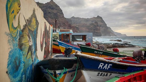 Fishing net and colorful boats on the coast with artistic walls, mural, graffiti and quiet evening