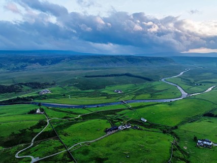 Forest in Teesdale over River Tees from a drone, North Pennines AONB, County Durham, England,