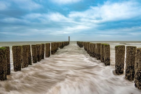 Coastal protection, through wooden posts, paalhoofden, on the beach, breakwater, the piles, some of