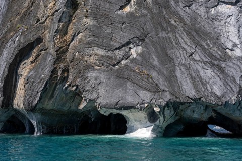 Marble caves (Capillas de Mármol) with eroded marble rock formations over turquoise-coloured water,