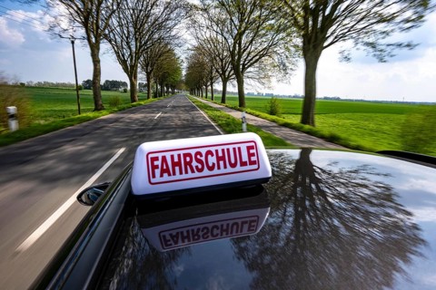 Symbolic picture driving school driving on a country road