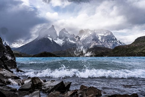 Cuernos del Paine, wind-whipped Lago Pehoé with spray and waves in the foreground, cloudy sky,