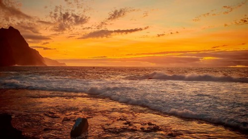 Ocean sunset with warm orange sky and calm waves, romantic, Ponta do Sol, Santo Antao, Cabo Verde,