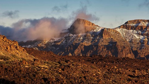 Mirador El Tabonal Negro, Caldera, cloud-covered mountain landscape in warm sunset with snow,