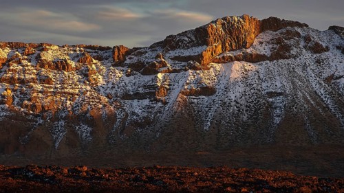 Mirador El Tabonal Negro, Caldera, snow-covered rocks illuminated by the setting sun, Teide