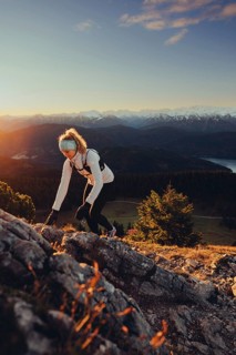 Trail running in autumn on the Jochberg on Lake Walchensee against the wonderful backdrop of the
