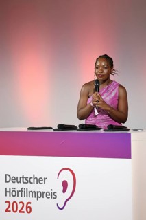 Kathy Etoa gives the laudatory speech for the documentary category at the German Audio Film Awards