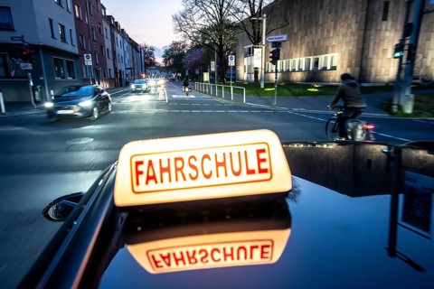 Symbolic picture of driving school, evening trip in the city center, urban traffic