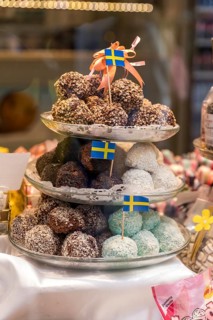 Small chocolates with Swedish flags in the shop window in Västerlånggatan, alley in the old town