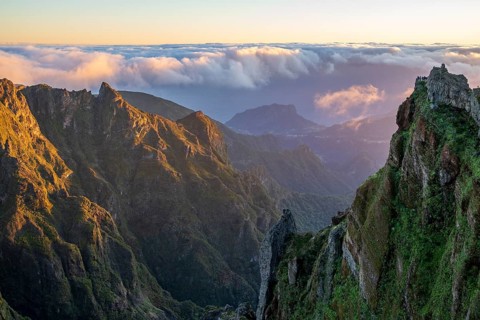 Sunrise at Pico do Arieiro, clouds of fog pass over mountain peaks, hiking trail PR1, Madeira,