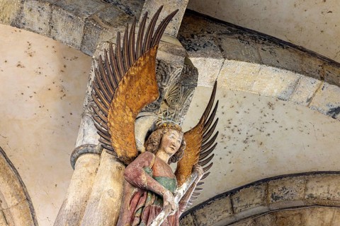Archangel Michael at the entrance to the portal of the parish church of St. Michael. City view of