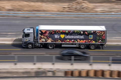 Freight truck for food logistics, on the motorway, supermarket chain EDEKA