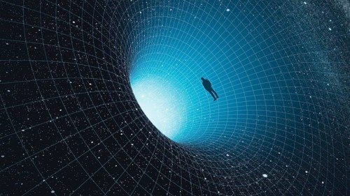 A man stands at the edge of a black hole, gazing into the depths of the universe, surrounded by