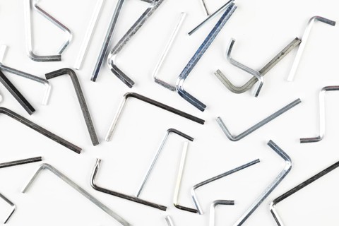Various L-shaped Allen wrenches scattered on a bright surface