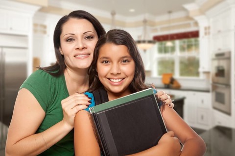 Proud Hispanic Mother and Daughter In Kitchen at Home Ready for School