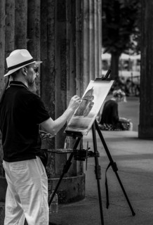 Black and white photograph, artist and painter with easel in the public street, Museum Island,