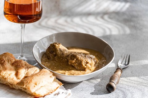 Enjoy a classic Georgian satsivi, tender chicken served in a creamy walnut sauce, accompanied by