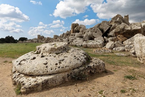 Very large base or capital in front, Doric column, in the back debris from Temple G, presumably