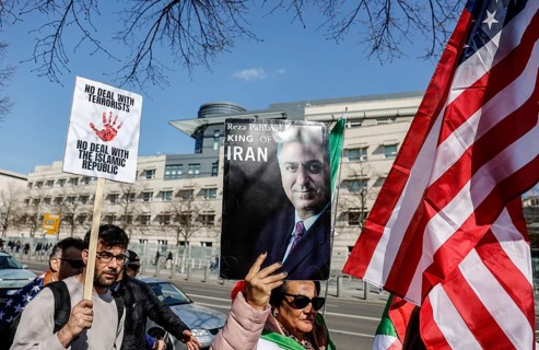 Iran demo for the end of the Islamist mullah regime in Iran, demonstrator holding a picture of