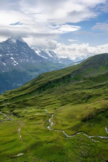 View of mountain landscape with green meadows and alpine huts Bachlager, Grindelwald First,